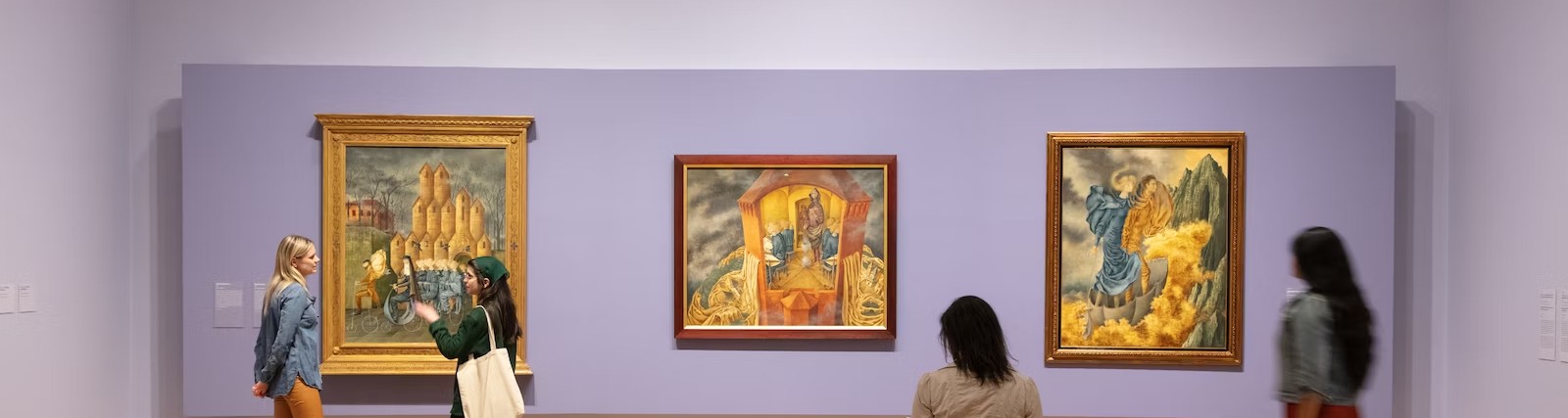 Gallery view of Remedios Varo paintings on a lavender wall